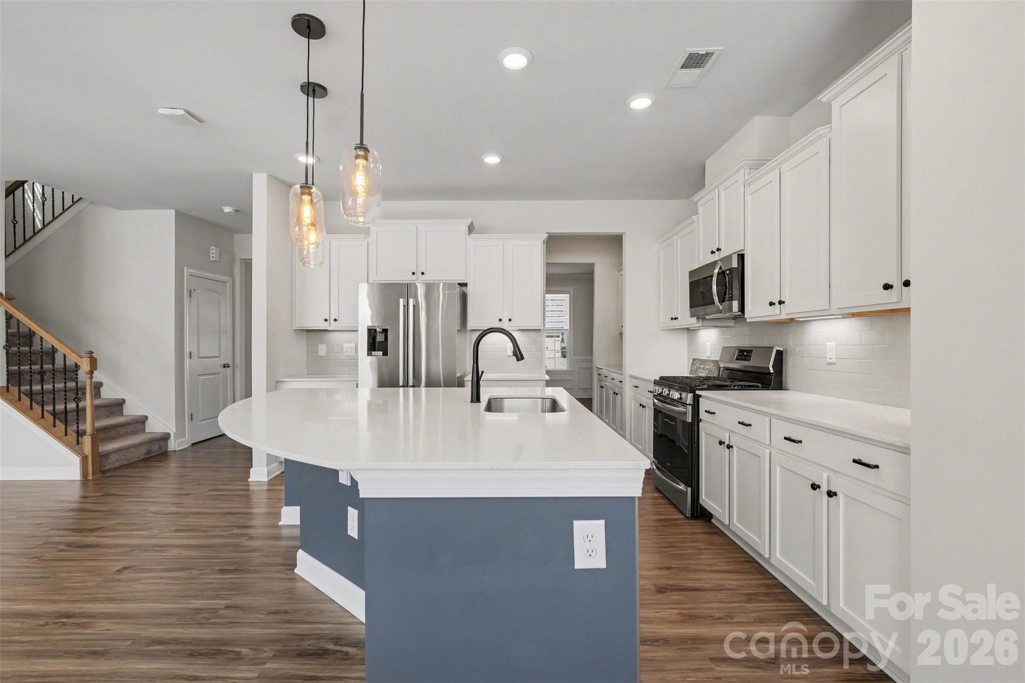 14510 Grundys Way Davidson, NC 28036 - Photo 11 of 43 a large kitchen with sink a center island stainless steel appliances and cabinets