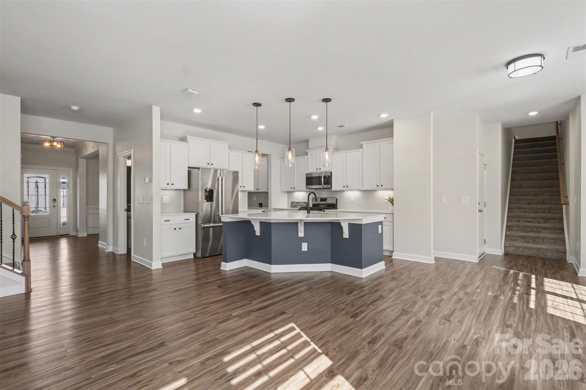 14510 Grundys Way Davidson, NC 28036 - Photo 13 of 43 a large kitchen with stainless steel appliances kitchen island a large counter top and a refrigerator
