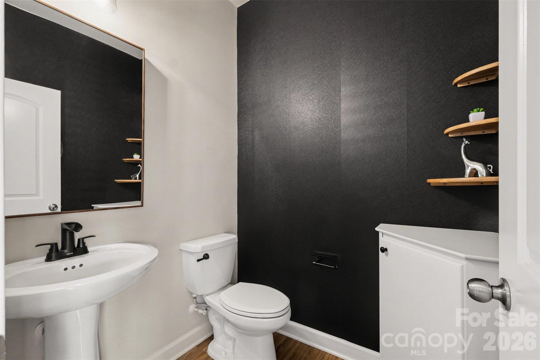 14510 Grundys Way Davidson, NC 28036 - Photo 18 of 43 a bathroom with a sink a toilet and a mirror