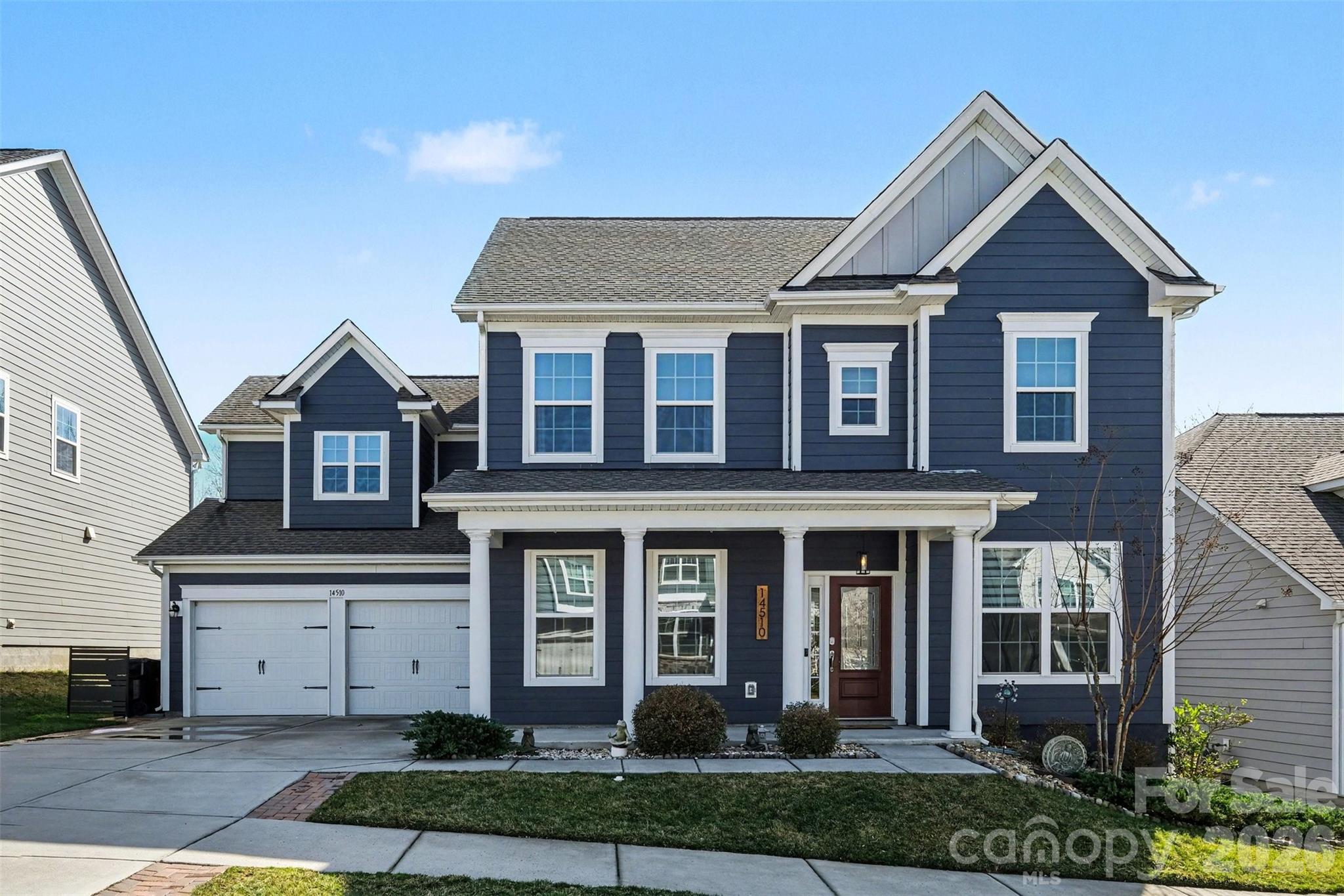 14510 Grundys Way Davidson, NC 28036 - Photo 2 of 43 a front view of a house with garden