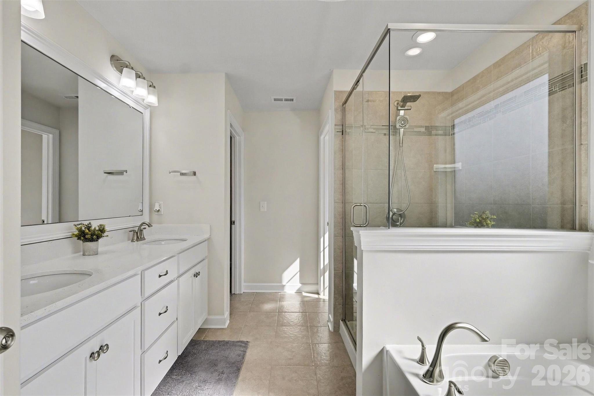 14510 Grundys Way Davidson, NC 28036 - Photo 22 of 43 a spacious bathroom with a granite countertop sink mirror and a