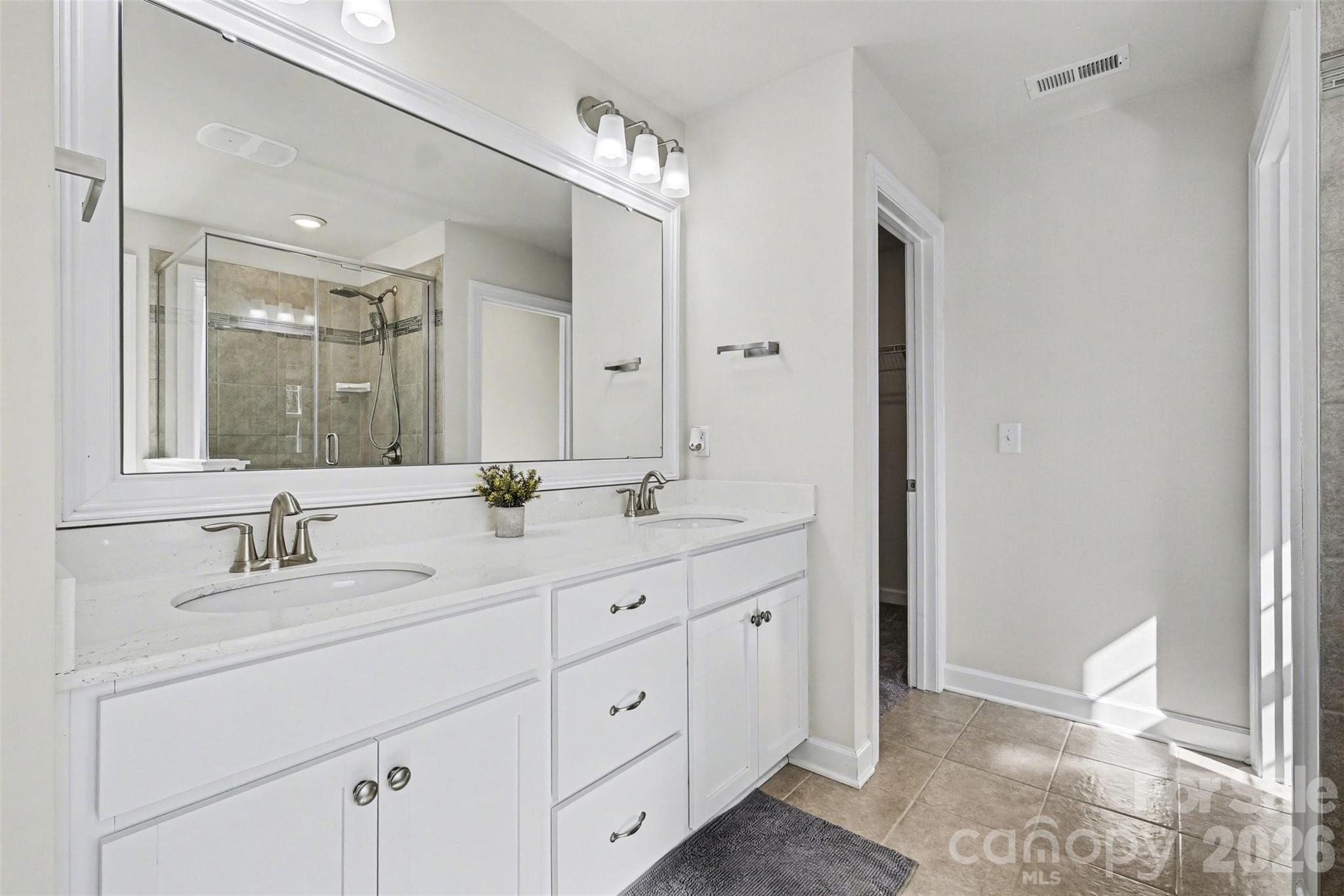 14510 Grundys Way Davidson, NC 28036 - Photo 23 of 43 a bathroom with a double vanity sink and a mirror