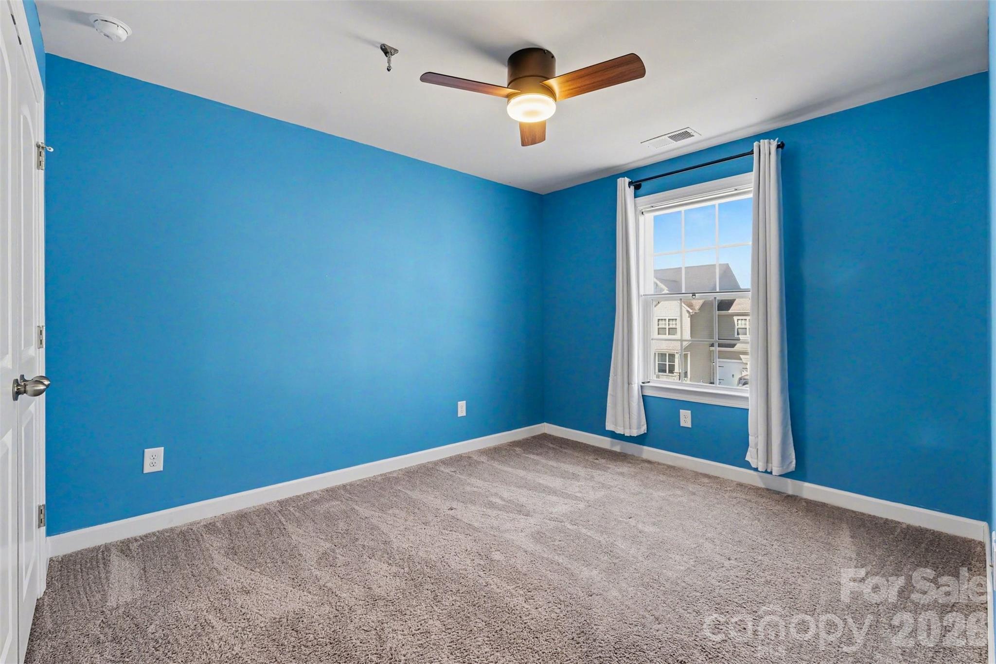 14510 Grundys Way Davidson, NC 28036 - Photo 26 of 43 an empty room with windows and chandelier fan