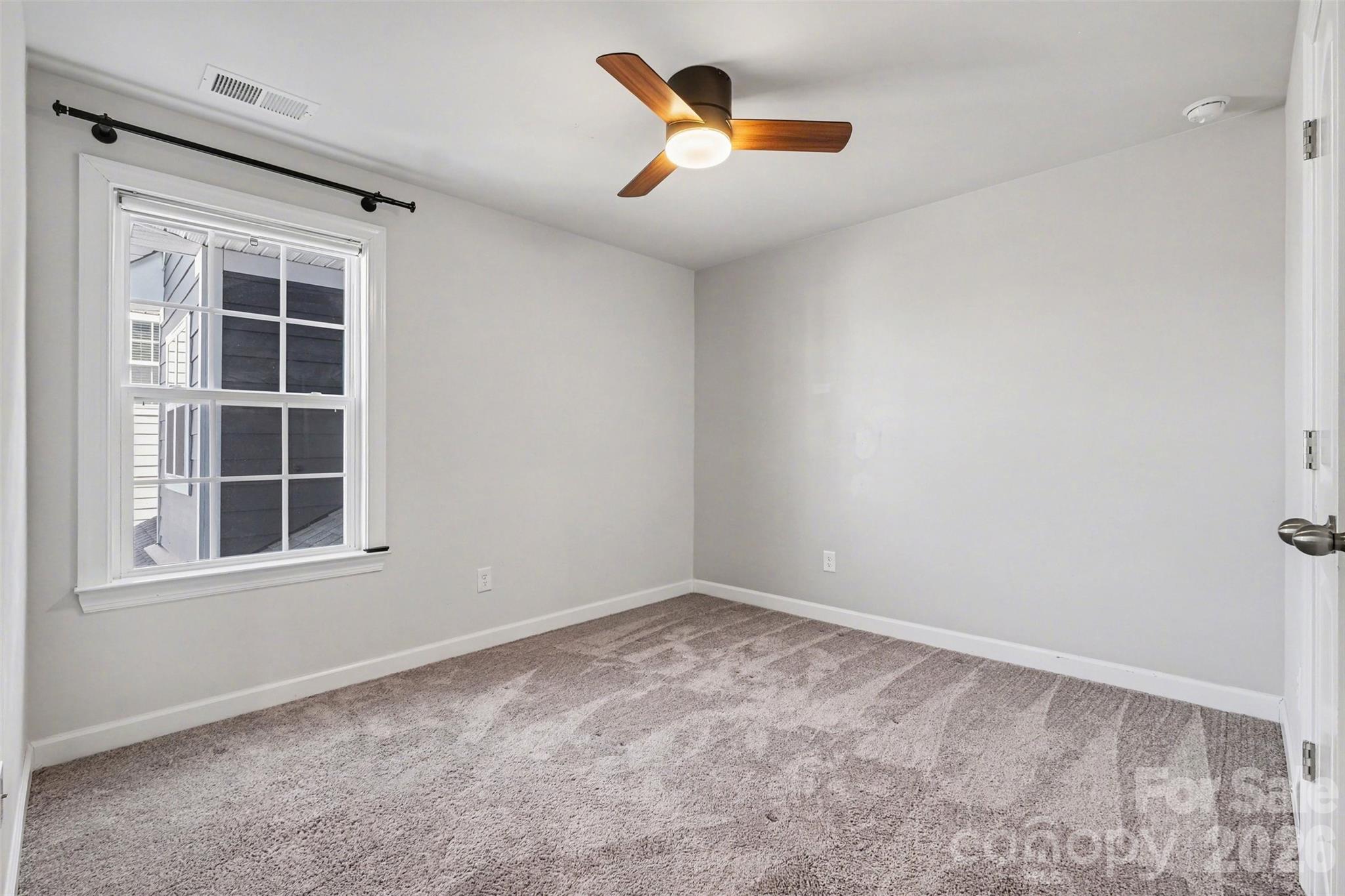 14510 Grundys Way Davidson, NC 28036 - Photo 30 of 43 an empty room with windows and a ceiling fan