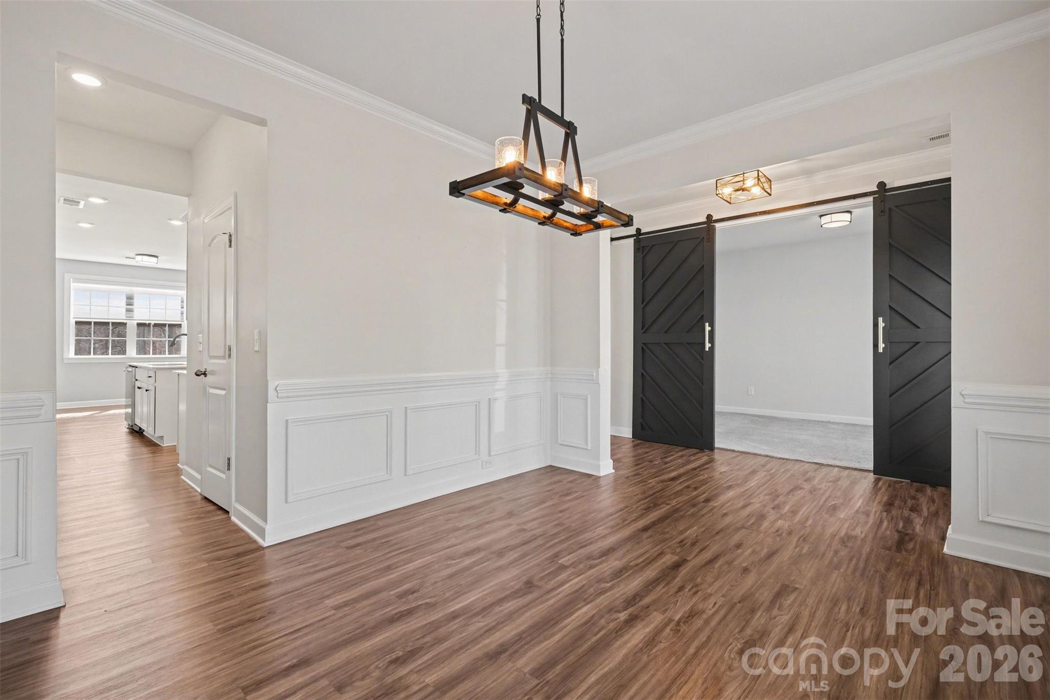 14510 Grundys Way Davidson, NC 28036 - Photo 5 of 43 a view of a hallway with wooden floor and chandelier