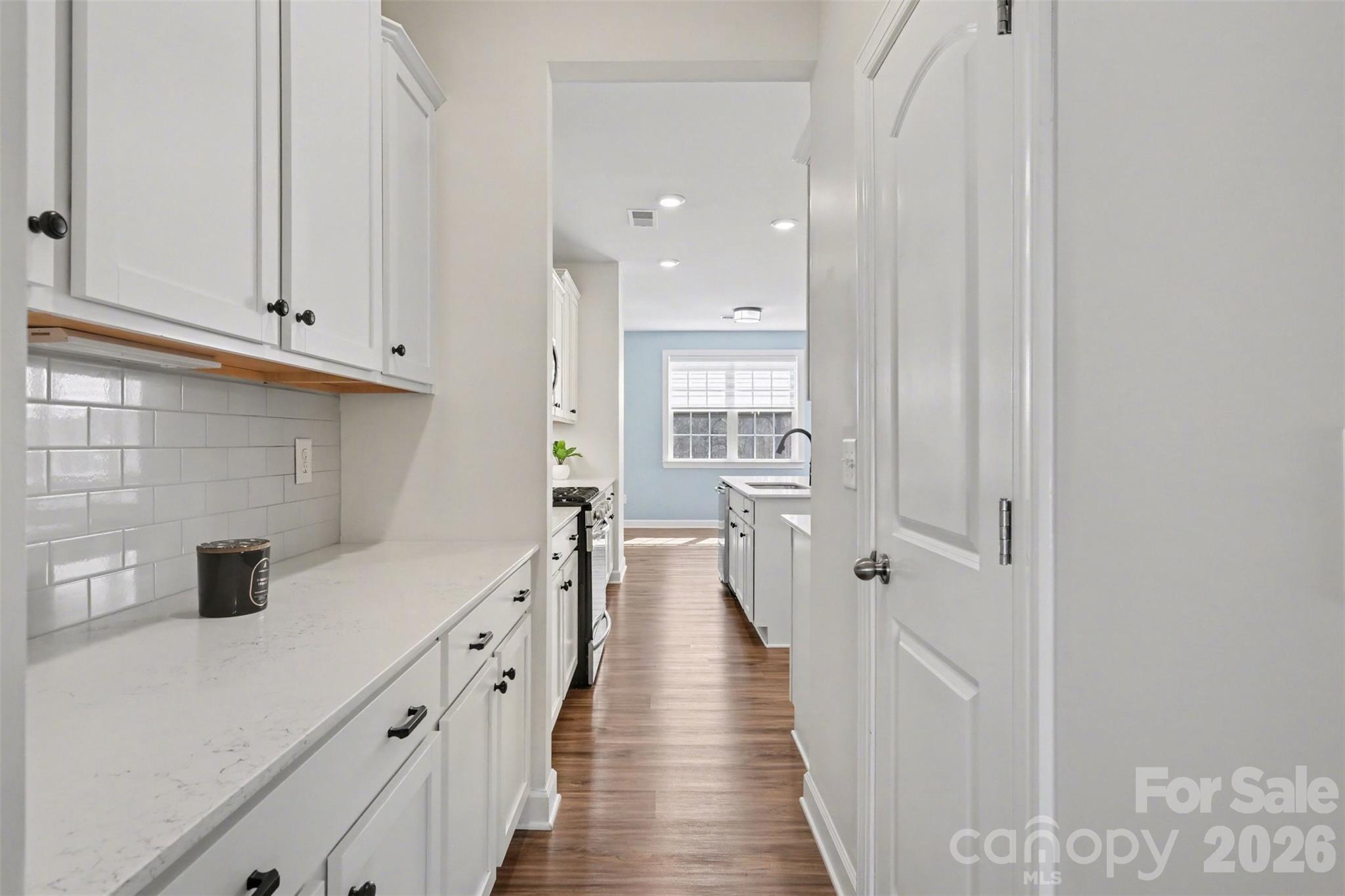 14510 Grundys Way Davidson, NC 28036 - Photo 8 of 43 a kitchen with cabinets and a wooden floor