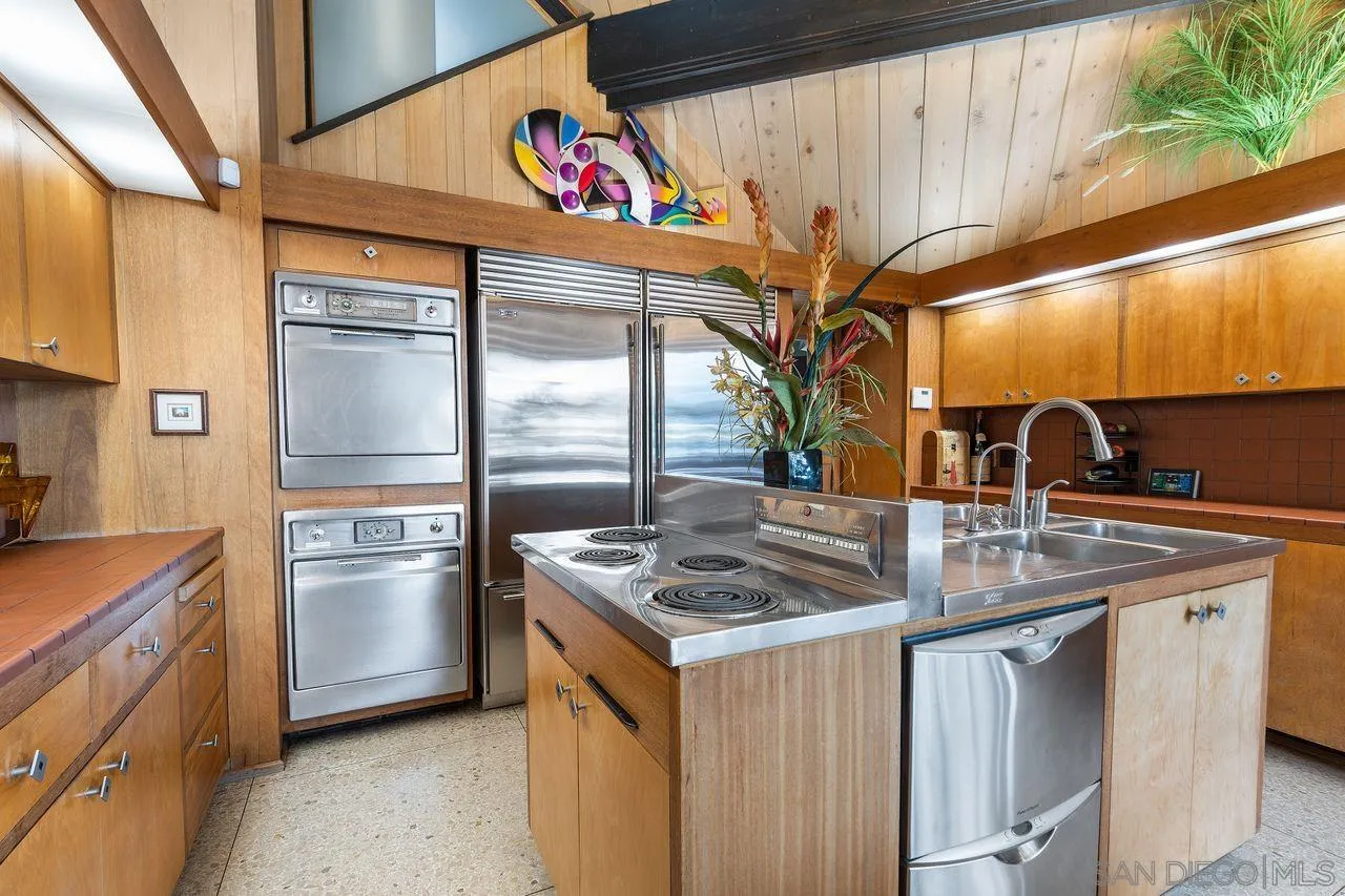 2694 Bayside Walk San Diego, CA 92109 - Photo 21 of 37 a kitchen that has a sink a stove and a refrigerator