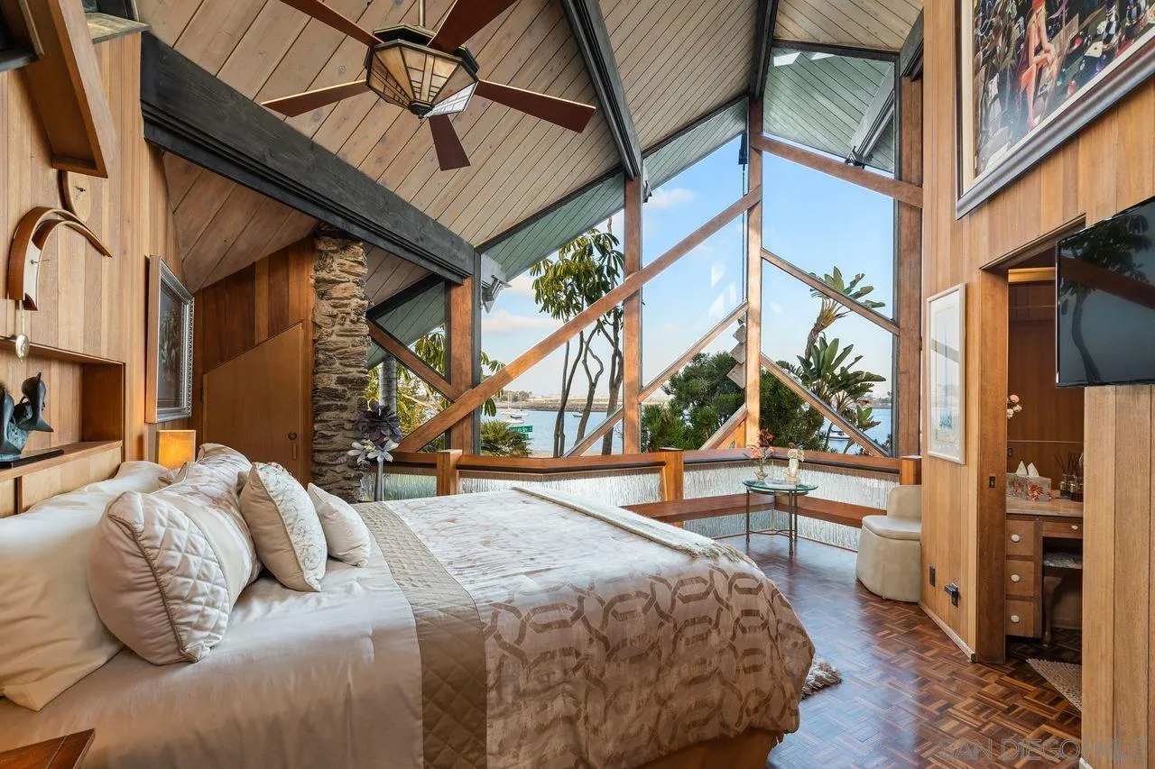 2694 Bayside Walk San Diego, CA 92109 - Photo 4 of 37 a bedroom with a bed a flat screen tv and a large window with the outer view