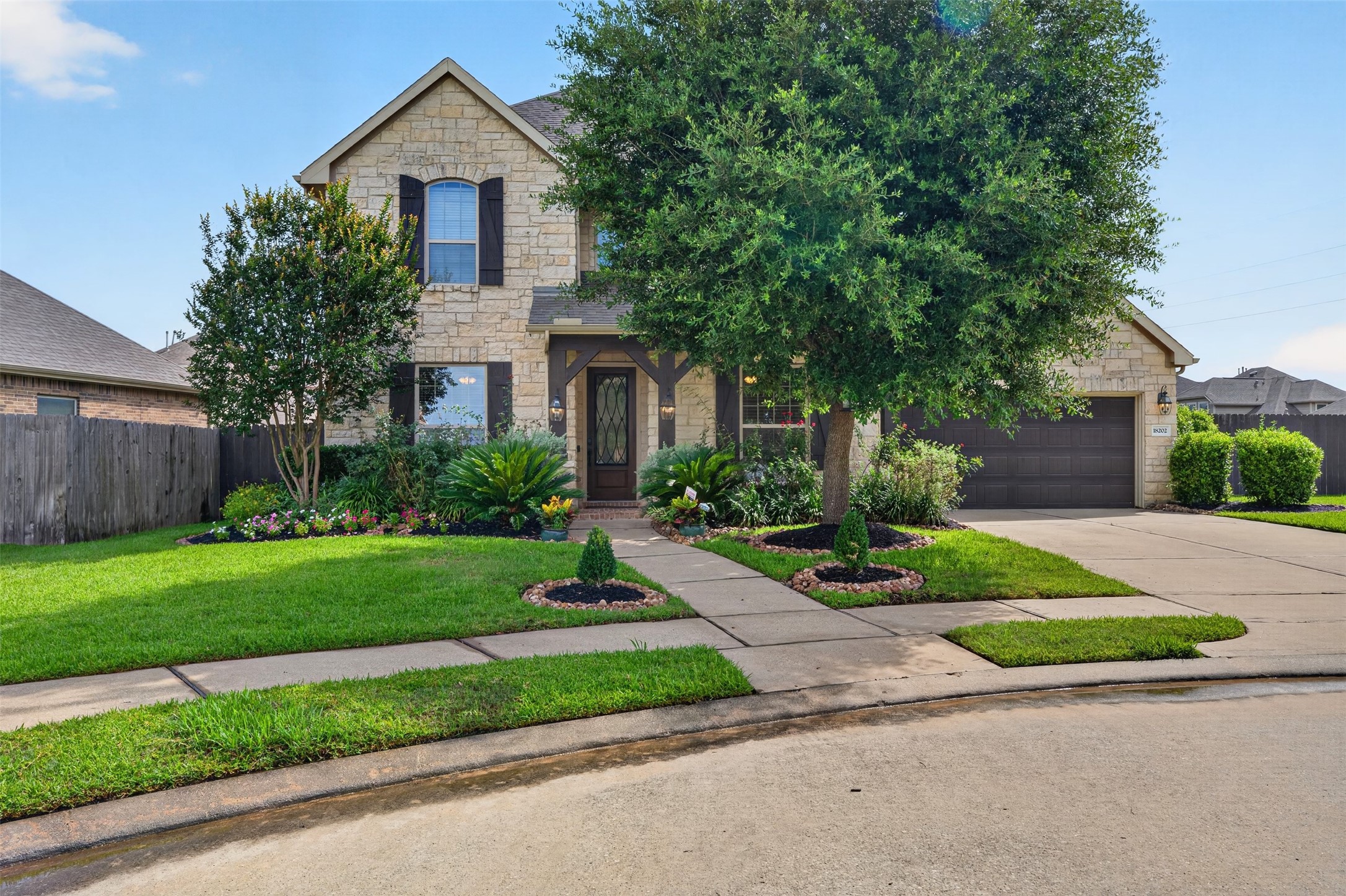 18202 Wedgewood Bluff Court Spring, TX 77379 - Photo 1 of 50 Beautiful two-story exterior with mature landscaping and a welcoming front elevation.