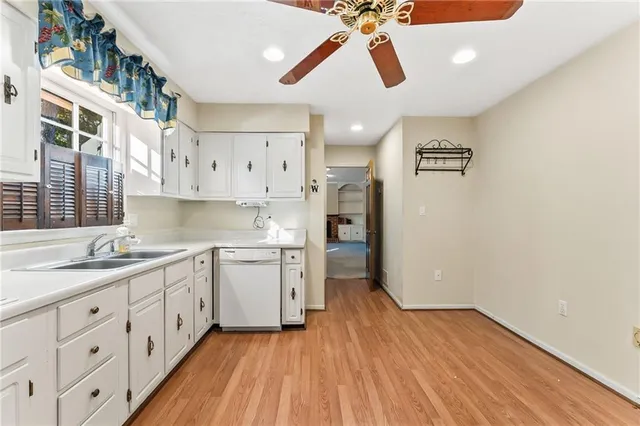 a kitchen with a sink window and stainless steel appliances
