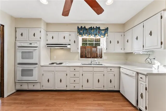 a kitchen with granite countertop a sink and a stove