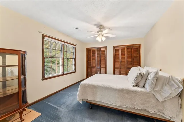 a bedroom with a large bed and a window