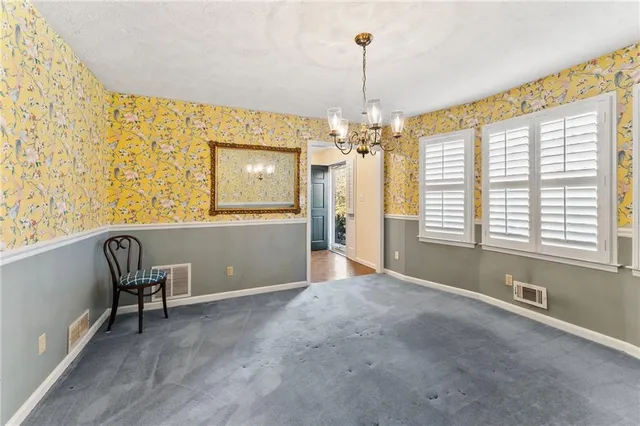 a view of a livingroom with a window and wooden floor