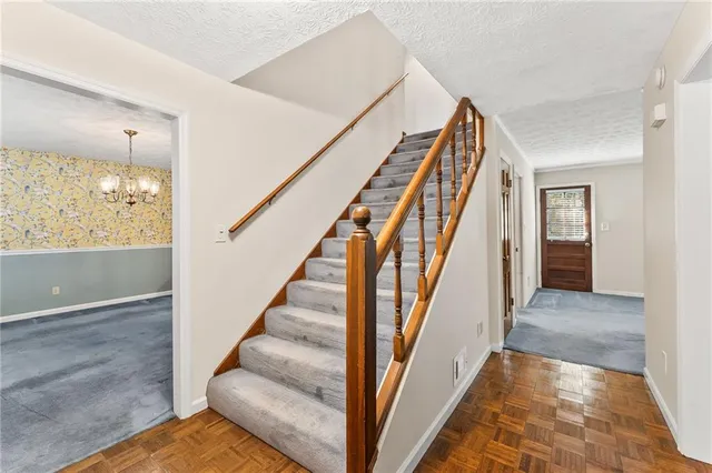 a view of an entryway with wooden floor and staircase