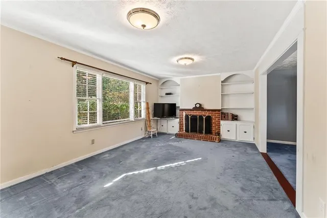 an empty room with furniture and a large window