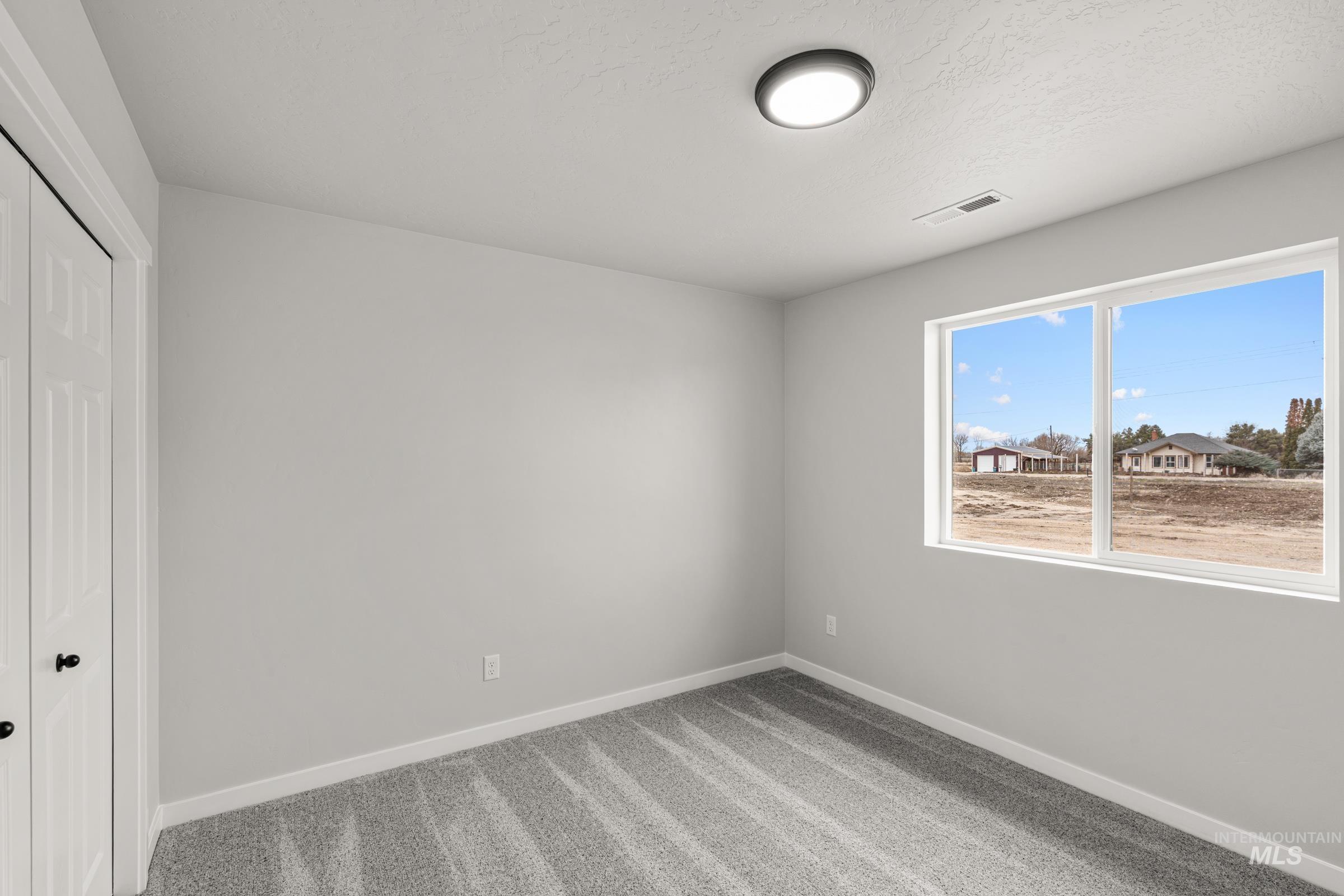 1449 Covington Street Middleton, ID 83644 - Photo 11 of 21 Unfurnished bedroom with a closet and light colored carpet