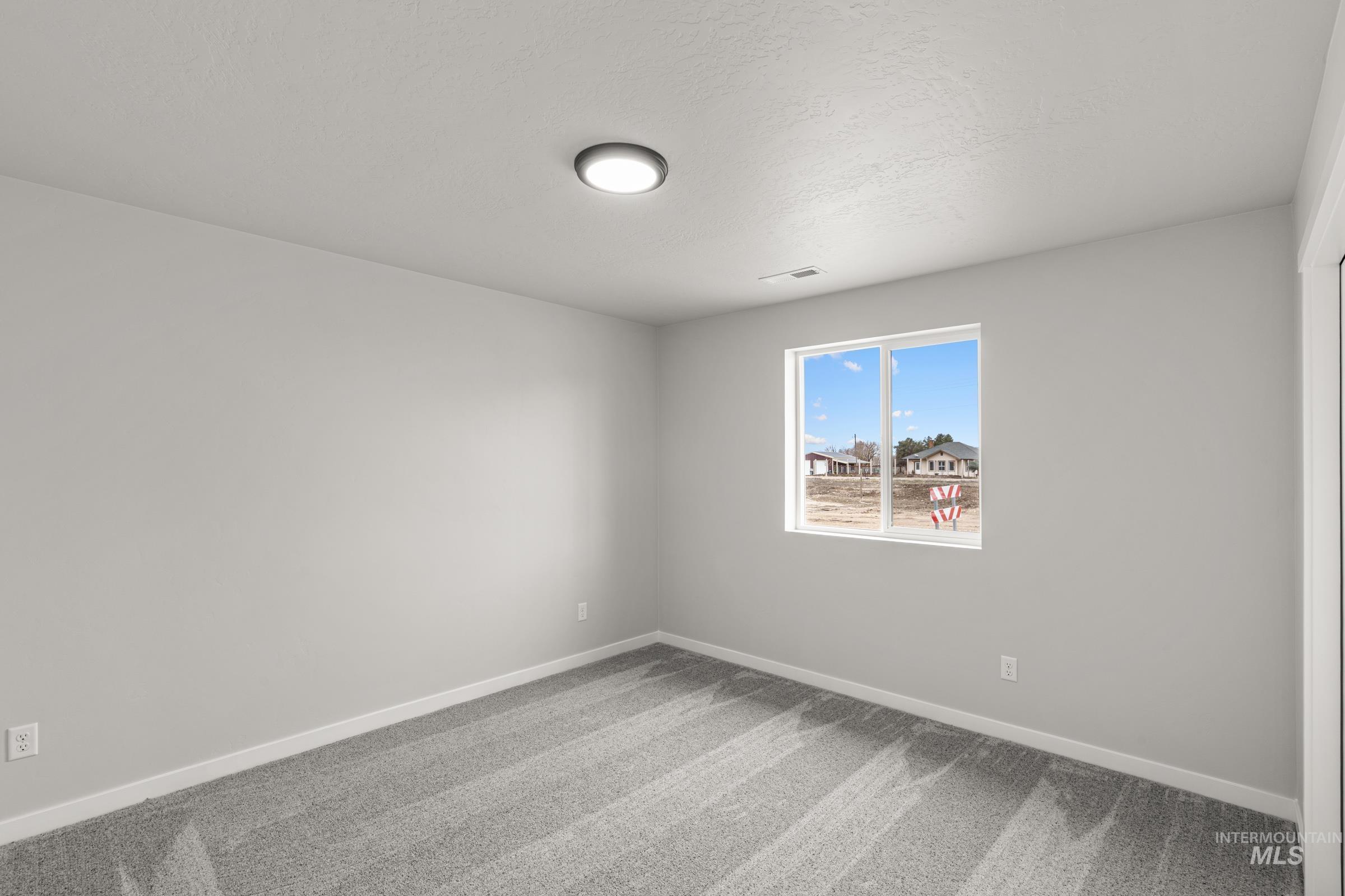 1449 Covington Street Middleton, ID 83644 - Photo 12 of 21 Empty room with carpet and baseboards