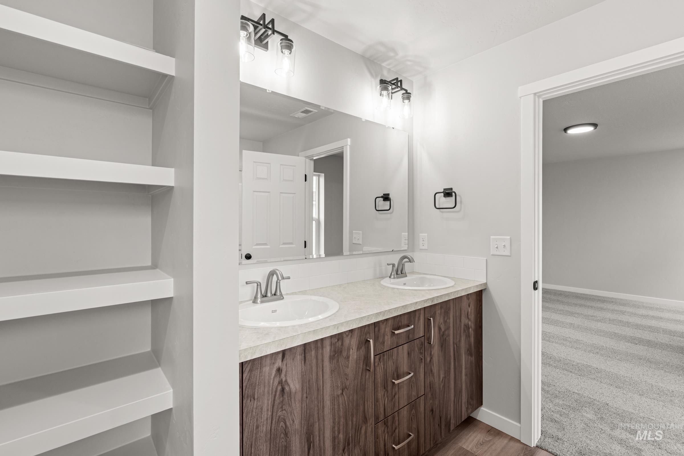 1449 Covington Street Middleton, ID 83644 - Photo 19 of 21 Full bathroom with double vanity and light wood-style flooring