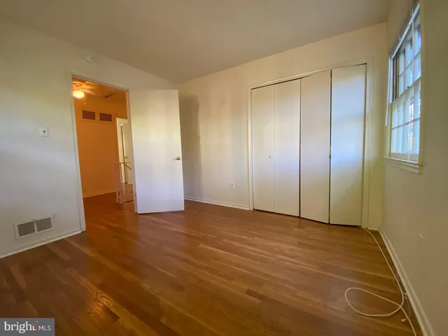 a view of a bedroom with wooden floor