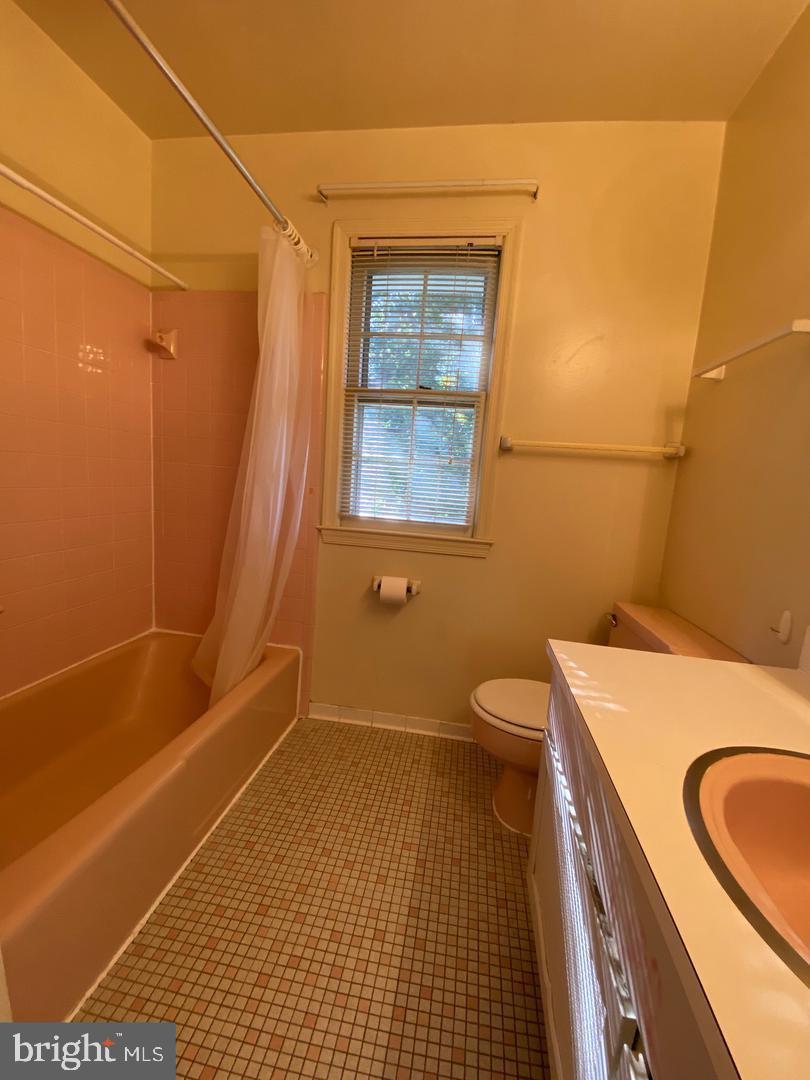 6731 Bellamy Avenue Springfield, VA 22152 - Photo 17 of 19 a bathroom with a granite countertop sink toilet and shower