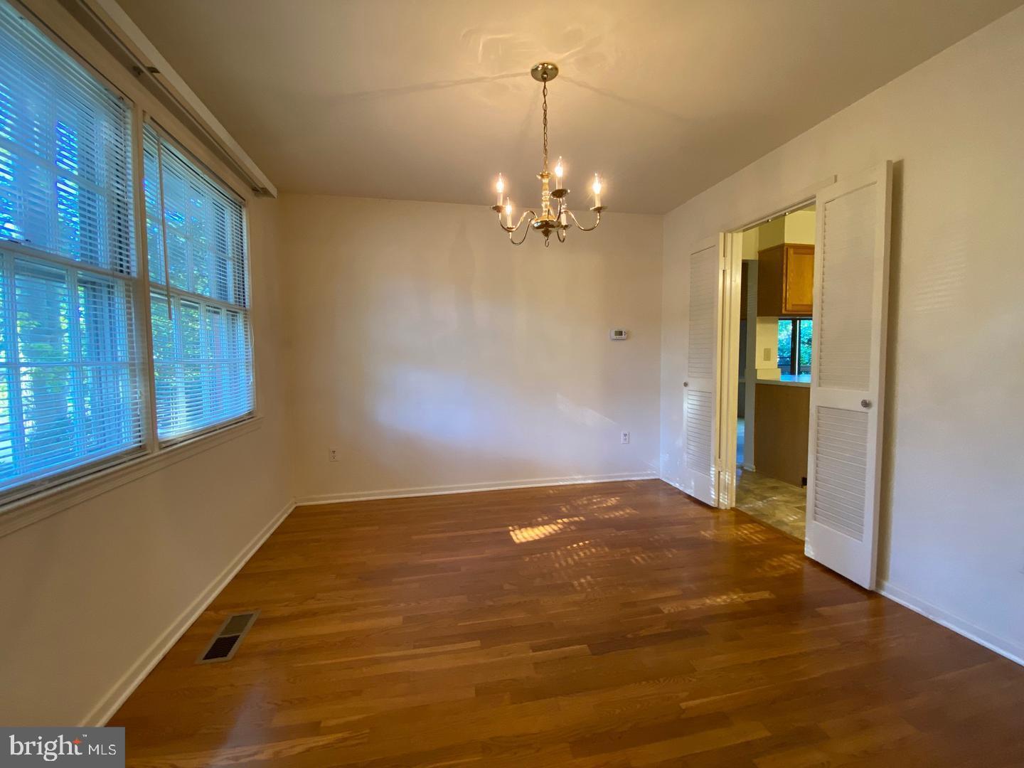 6731 Bellamy Avenue Springfield, VA 22152 - Photo 7 of 19 a view of an empty room with window and chandelier fan