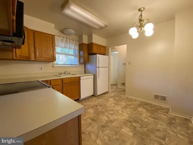 a kitchen with a sink cabinets and window