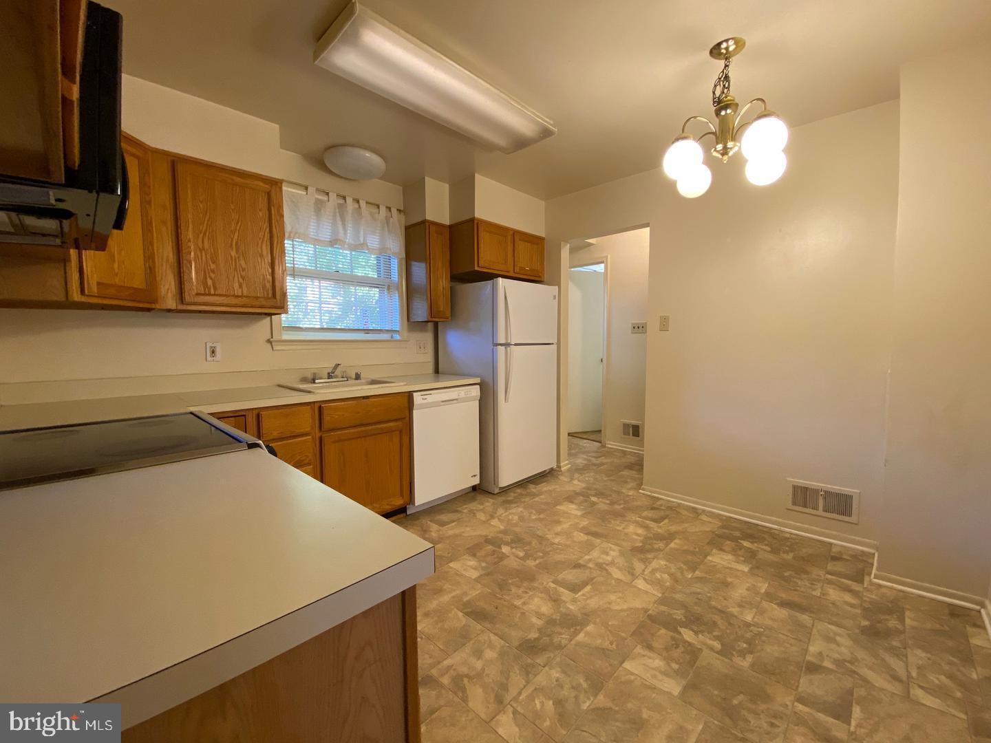 6731 Bellamy Avenue Springfield, VA 22152 - Photo 8 of 19 a kitchen with a sink cabinets and window