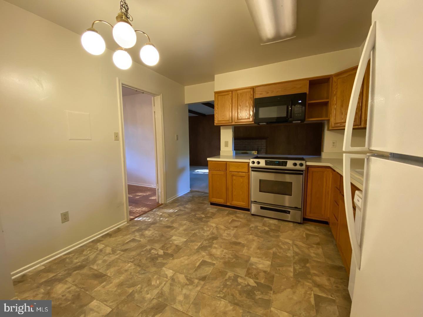 6731 Bellamy Avenue Springfield, VA 22152 - Photo 9 of 19 a kitchen with microwave cabinets and stainless steel appliances