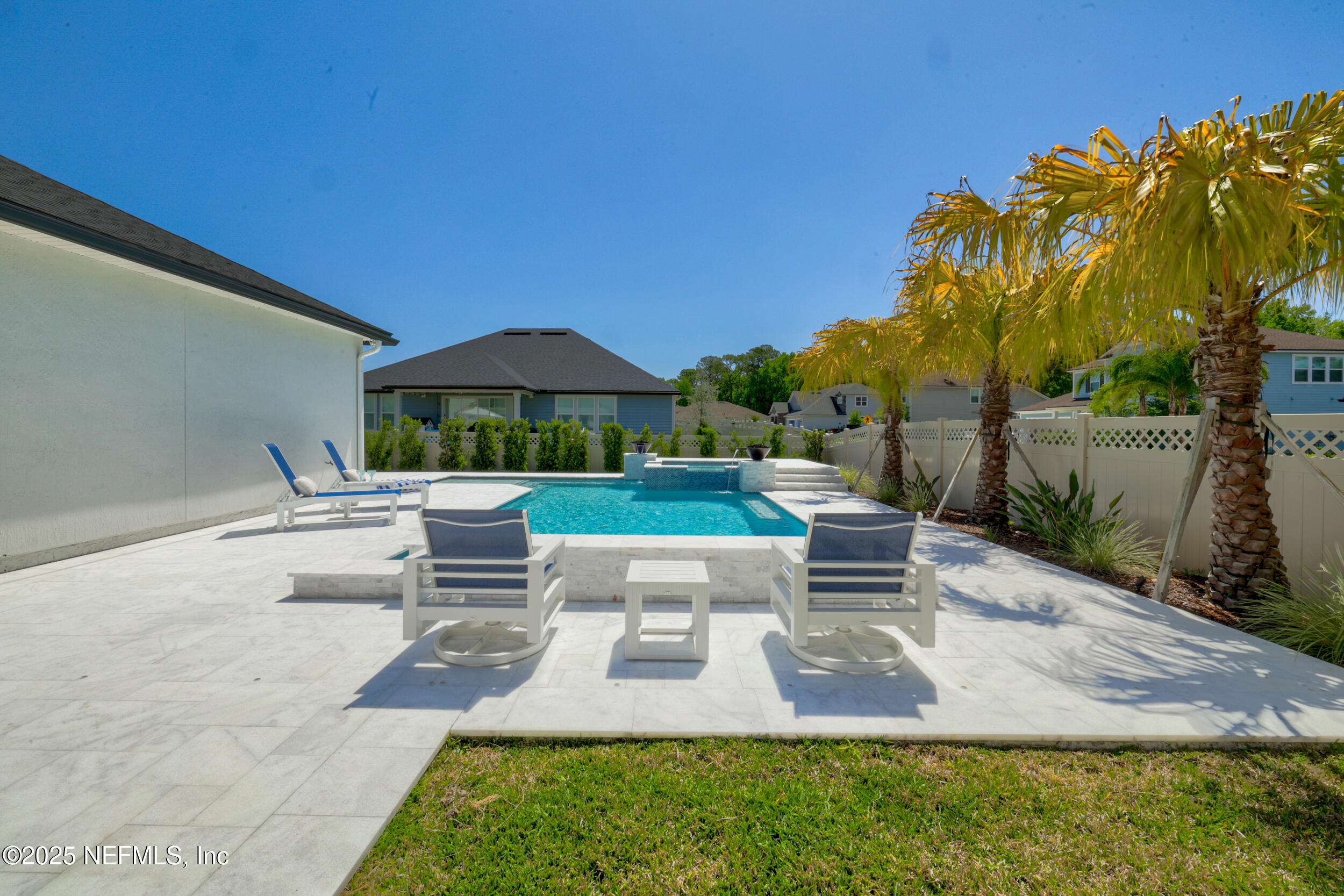 318 Windwalker Drive St. Augustine, FL 32092 - Photo 14 of 54 a view of a patio with couches and a table and chairs under an umbrella