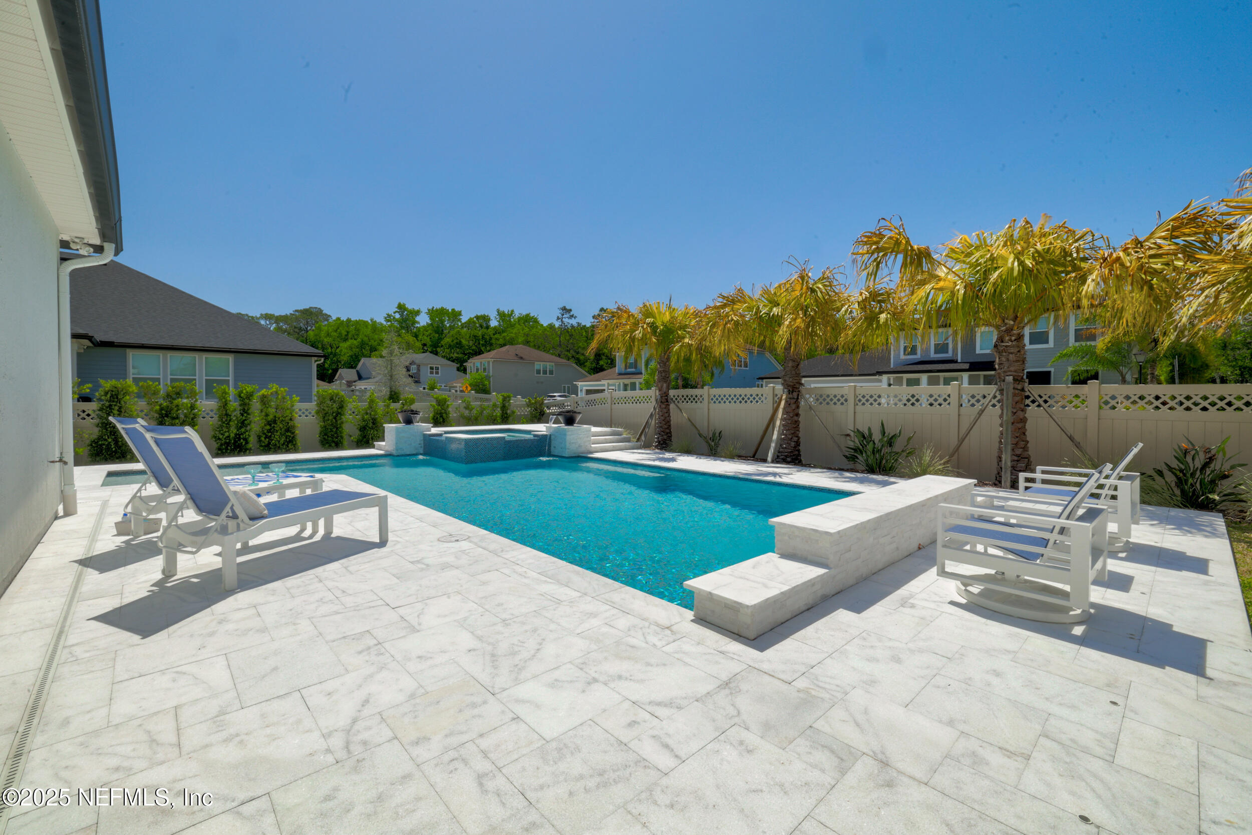 318 Windwalker Drive St. Augustine, FL 32092 - Photo 15 of 54 a view of swimming pool with seating space and wooden fence