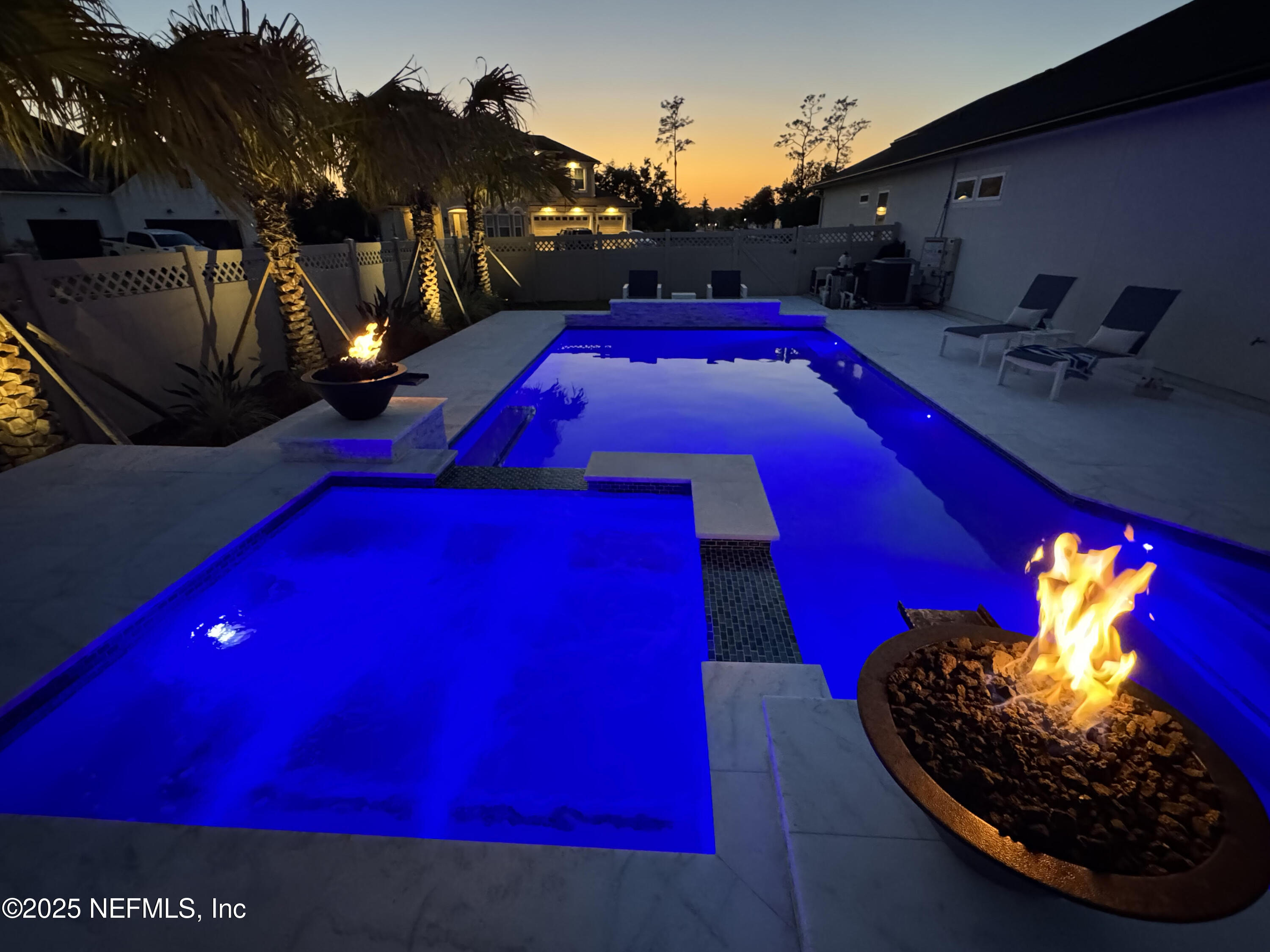 318 Windwalker Drive St. Augustine, FL 32092 - Photo 2 of 54 a view of swimming pool with a red chairs in front of house