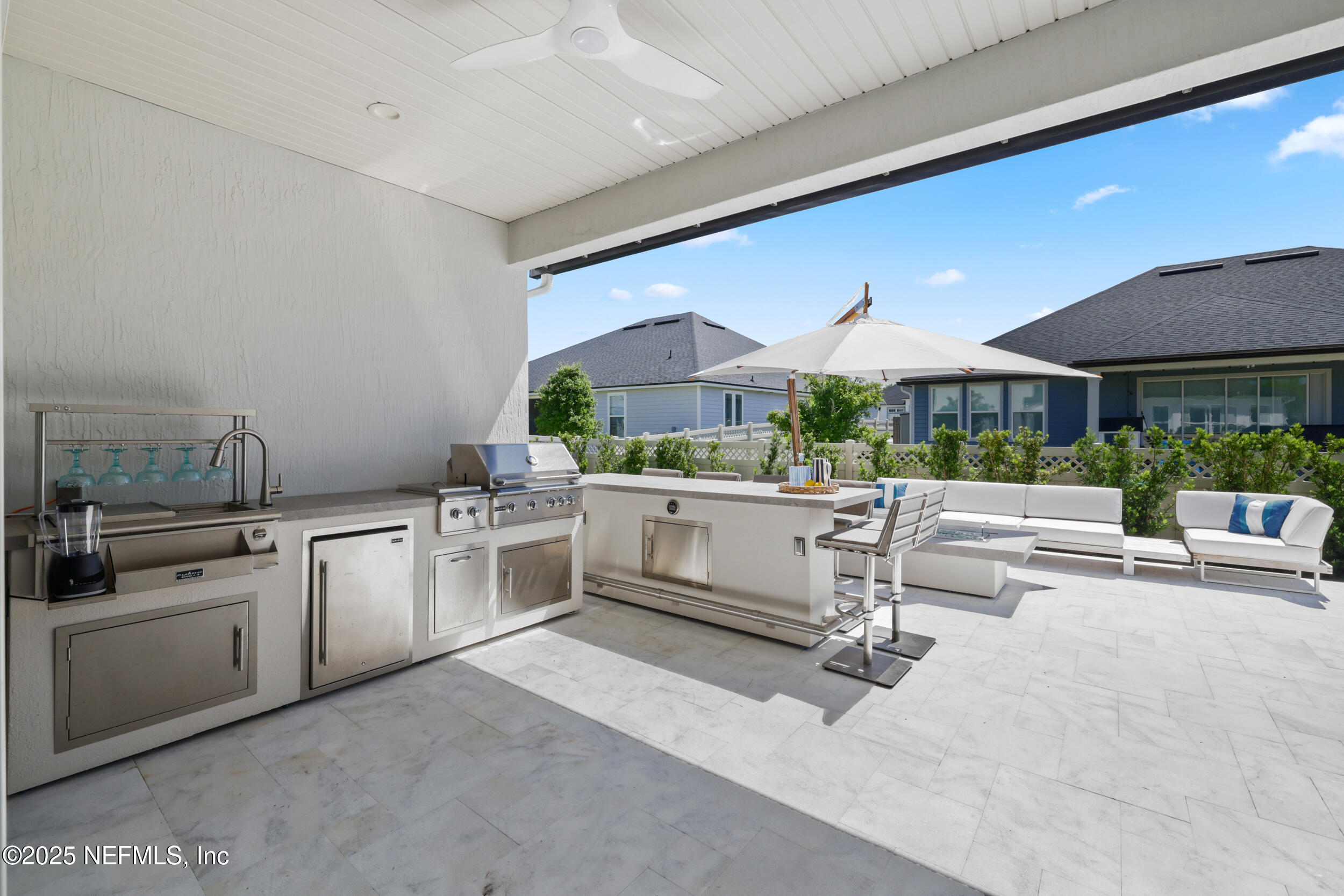 318 Windwalker Drive St. Augustine, FL 32092 - Photo 22 of 54 a kitchen with stainless steel appliances kitchen island granite countertop a stove and white cabinets