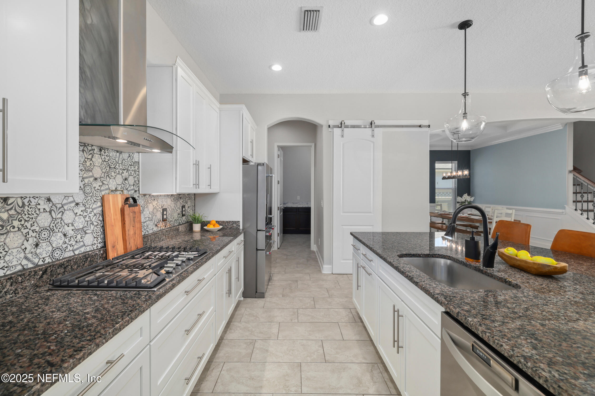 318 Windwalker Drive St. Augustine, FL 32092 - Photo 28 of 54 a kitchen with granite countertop a sink and a stove