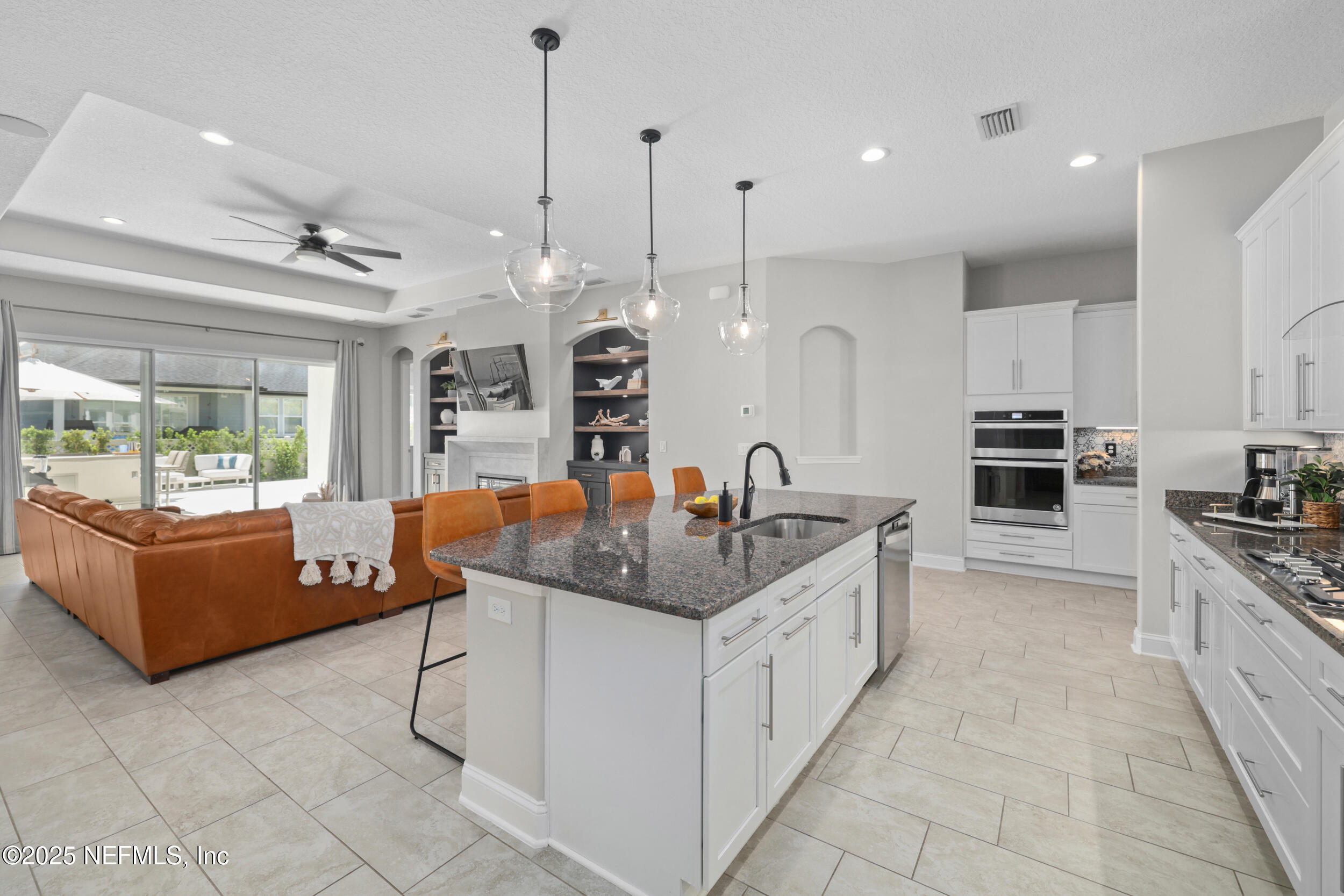 318 Windwalker Drive St. Augustine, FL 32092 - Photo 30 of 54 a kitchen with granite countertop a sink and white cabinets