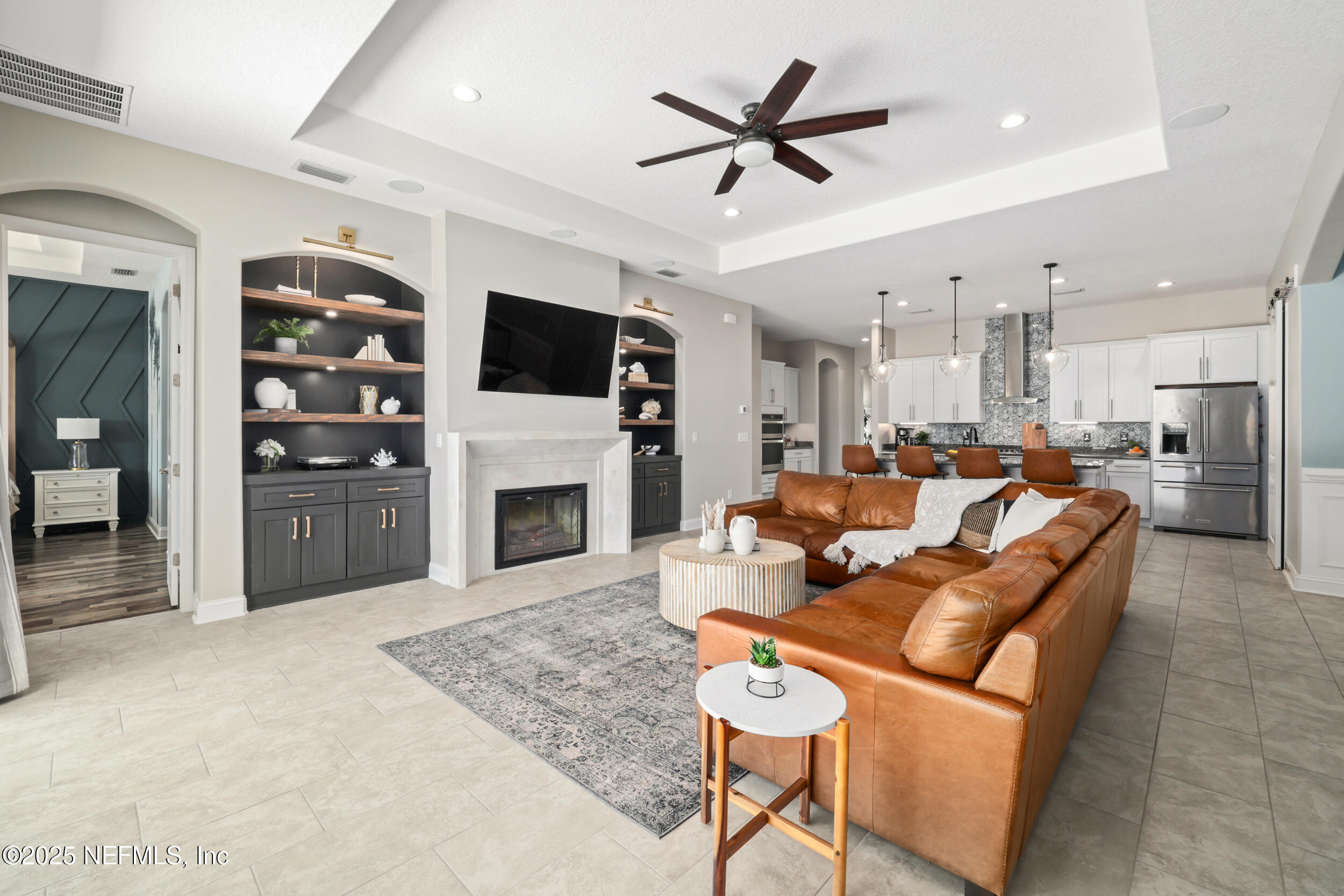 318 Windwalker Drive St. Augustine, FL 32092 - Photo 3 of 54 a living room with furniture a fireplace and a flat screen tv