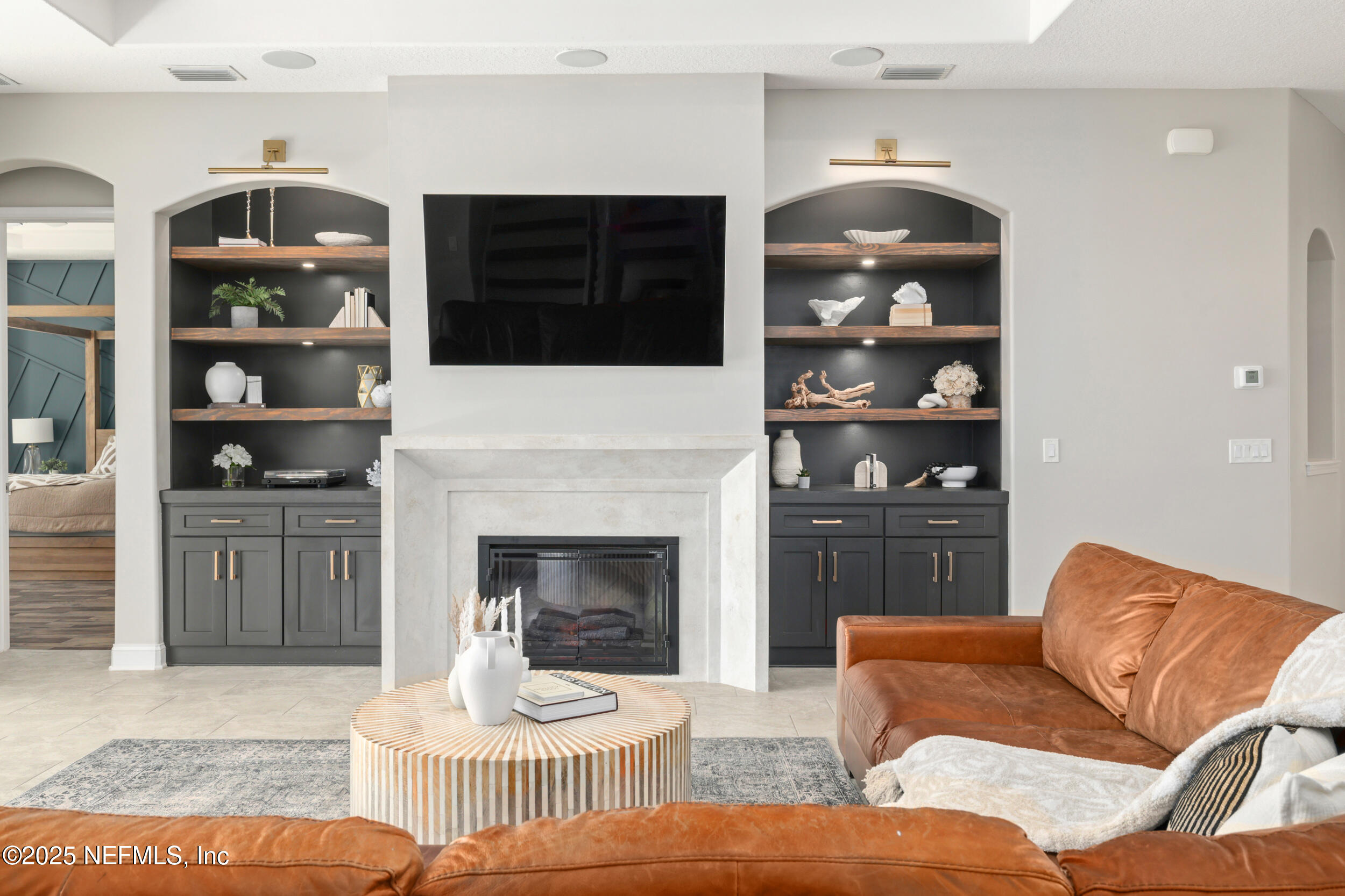 318 Windwalker Drive St. Augustine, FL 32092 - Photo 31 of 54 a living room with furniture a fireplace and a flat screen tv