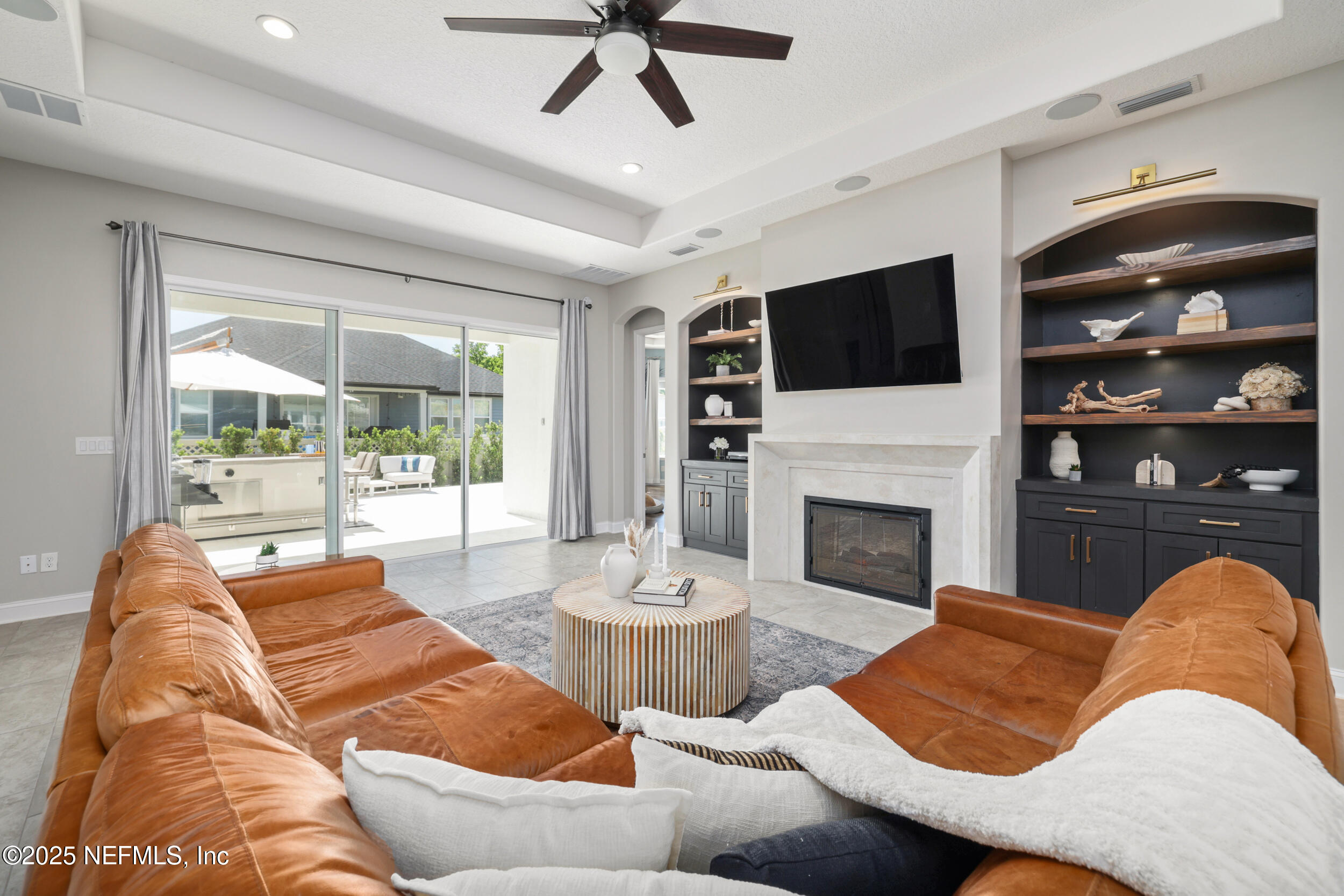 318 Windwalker Drive St. Augustine, FL 32092 - Photo 32 of 54 a living room with furniture fireplace and flat screen tv