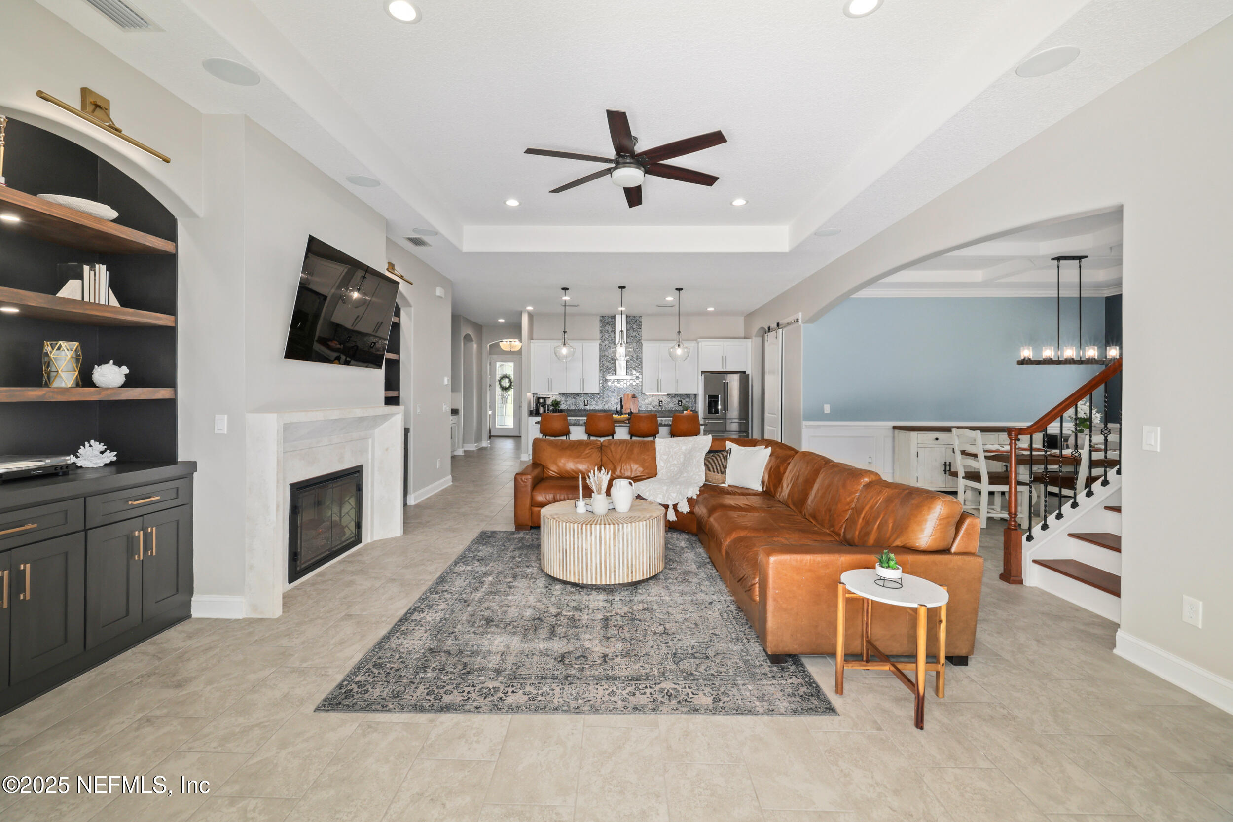 318 Windwalker Drive St. Augustine, FL 32092 - Photo 34 of 54 a living room with fireplace furniture and a flat screen tv