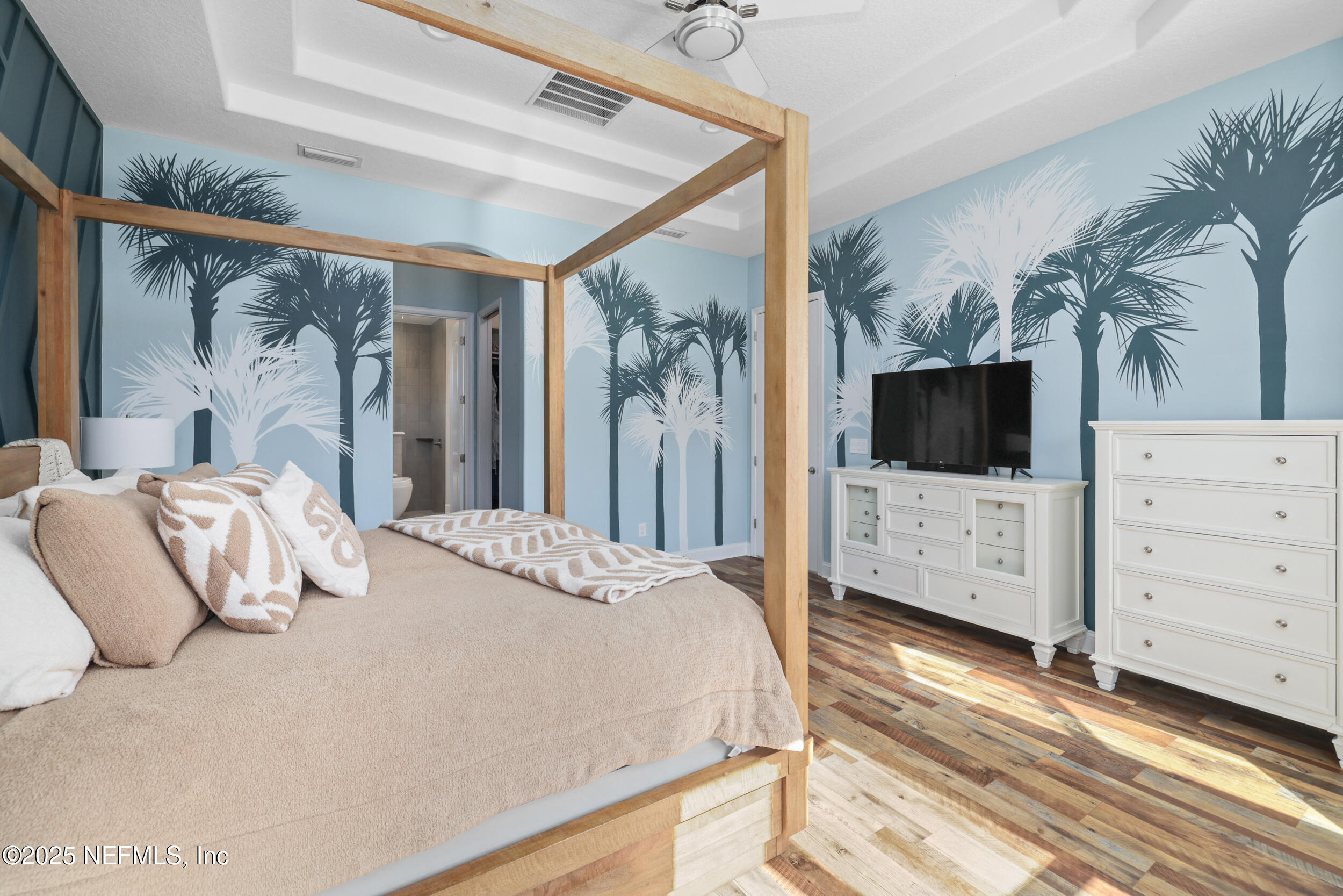 318 Windwalker Drive St. Augustine, FL 32092 - Photo 38 of 54 a bedroom with a large bed and a flat tv screen on dresser