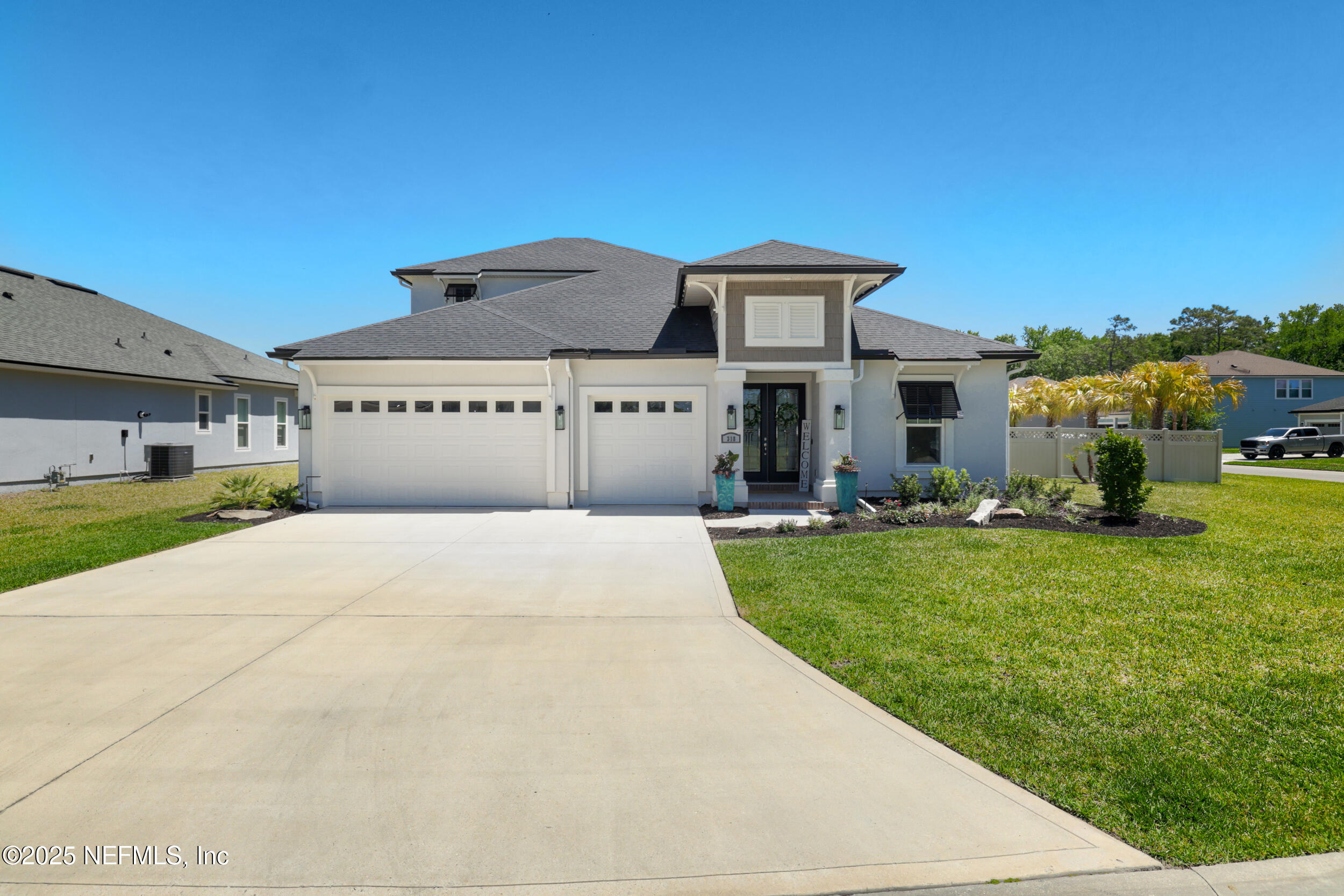 318 Windwalker Drive St. Augustine, FL 32092 - Photo 4 of 54 a front view of a house with a garden