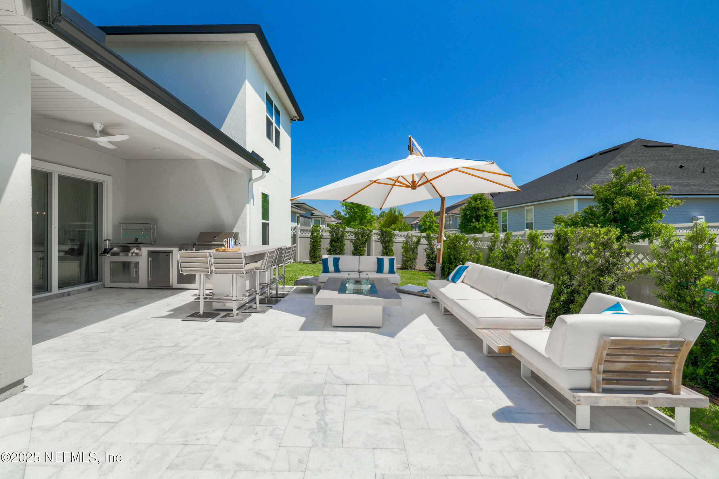 318 Windwalker Drive St. Augustine, FL 32092 - Photo 7 of 54 a view of a patio with a table and chairs under an umbrella
