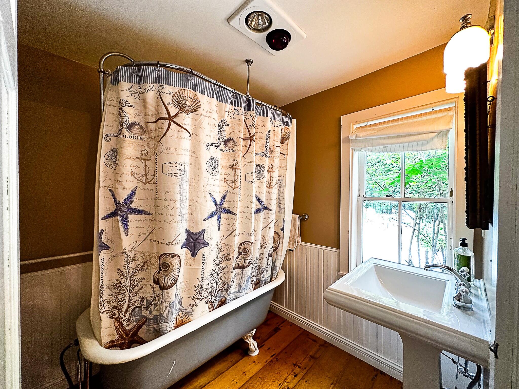 1319 Newbury Neck Road Surry, ME 04684 - Photo 25 of 68 1st floor bath w/claw foot surround.