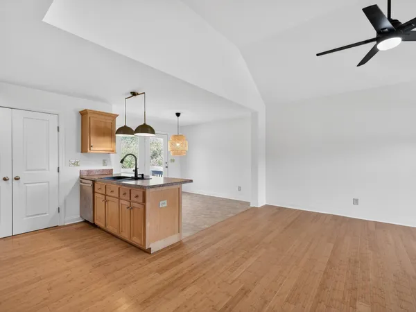 a kitchen with granite countertop a sink stainless steel appliances and cabinets