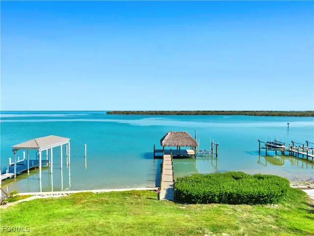 a view of a swimming pool with lawn chairs