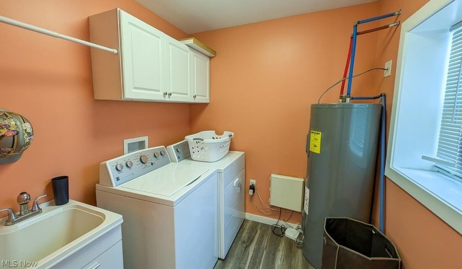 41 Poplar Street Huron, OH 44839 - Photo 21 of 37 Laundry area with water heater, washer and clothes dryer, cabinet space, and wood-style floors