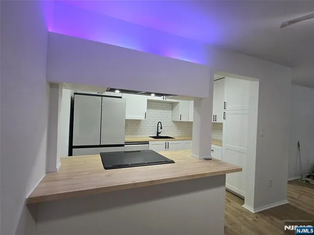 a kitchen with a sink and a refrigerator