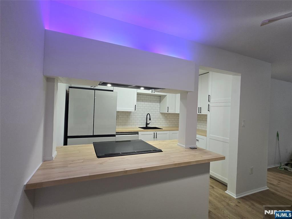 a kitchen with a sink and a refrigerator