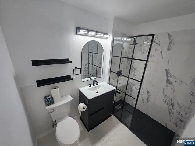 a bathroom with a sink toilet and mirror
