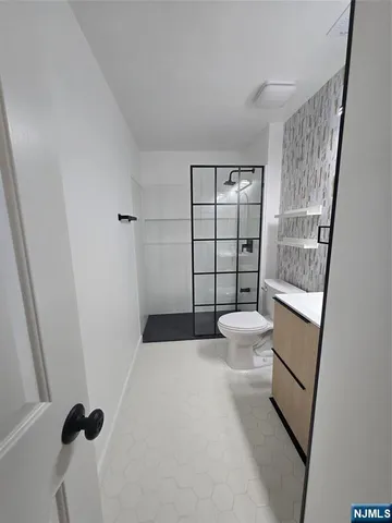 a bathroom with a toilet and a shower