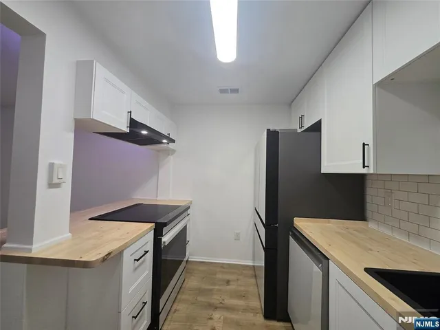 a kitchen with a stove and a refrigerator